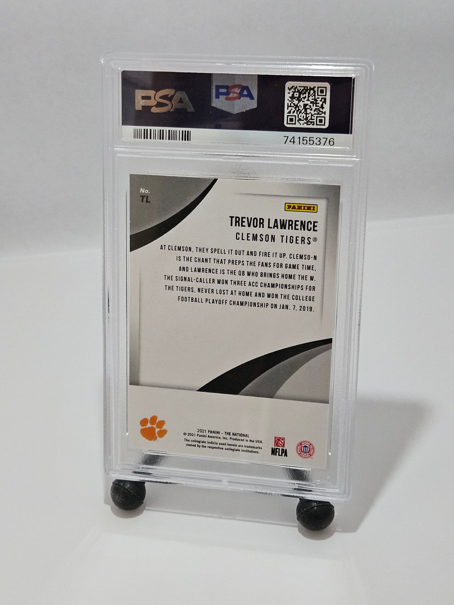 Trading card of Trevor Lawrence in a protective case on a white background