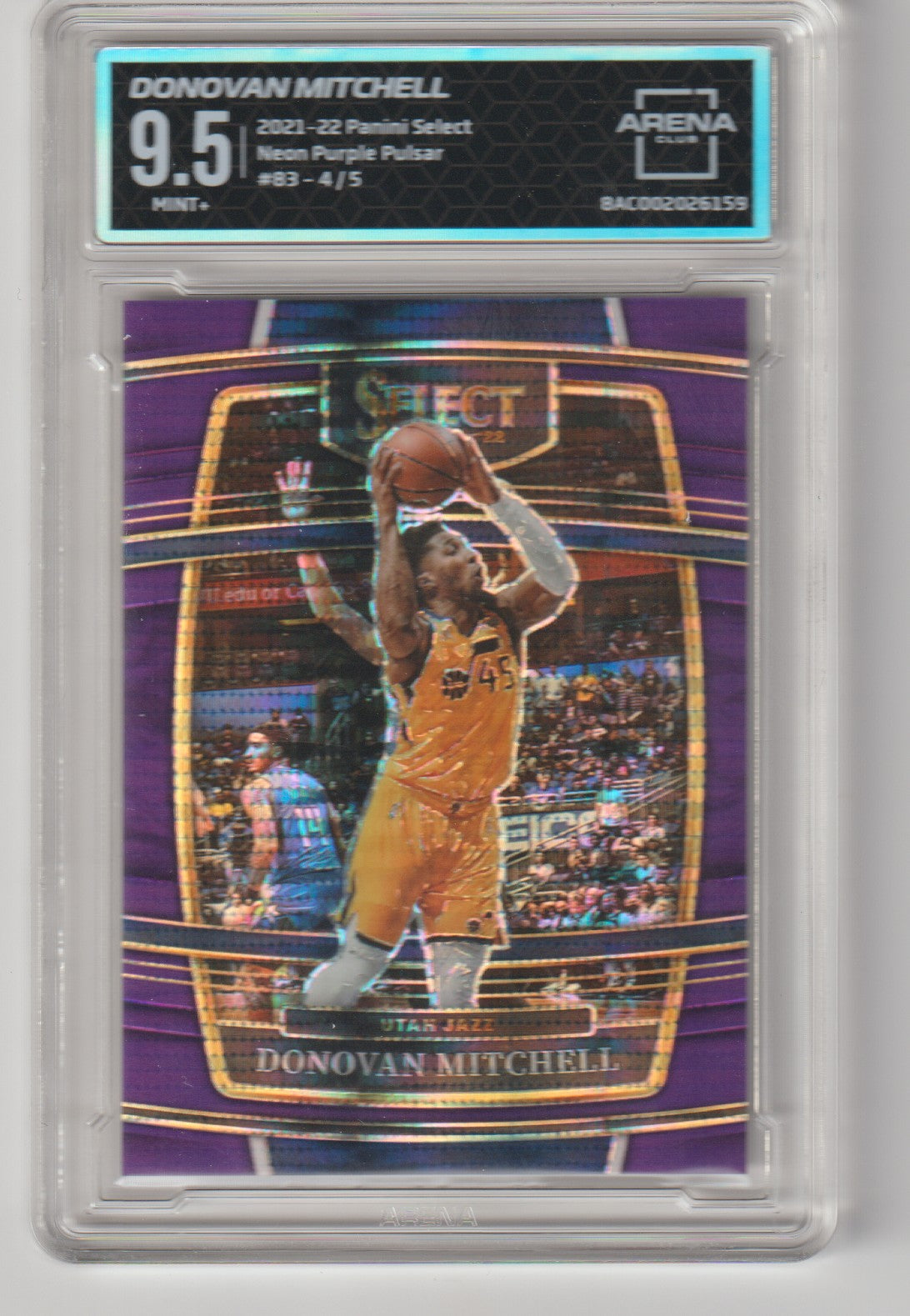 Basketball trading card of Donovan Mitchell with a purple and gold design, featuring a player in action pose.