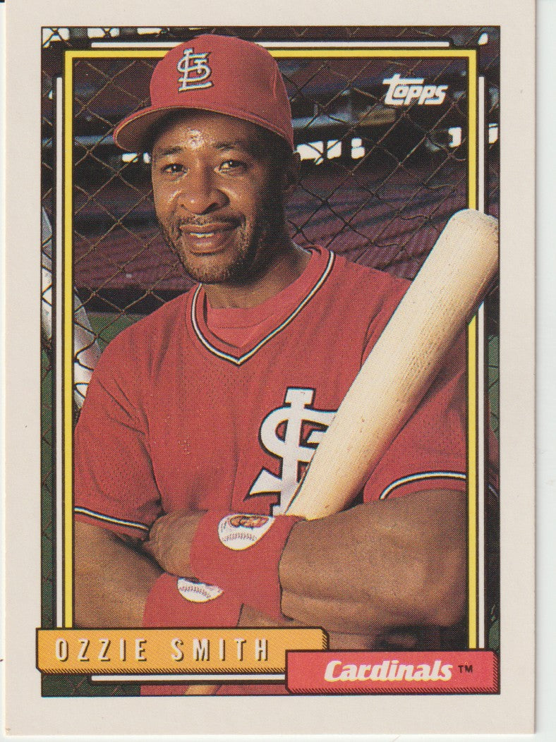 Baseball trading card of Ozzie Smith holding a bat, with St. Louis Cardinals logo.