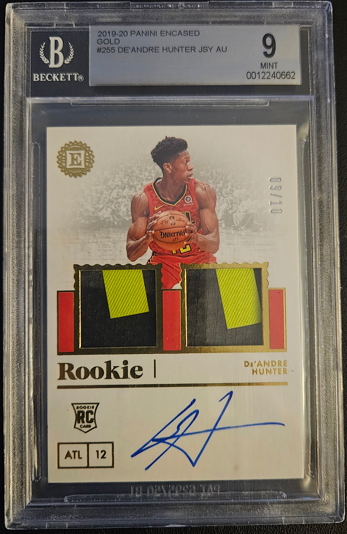 Basketball trading card with player image, signature, and 'Rookie' label in a protective case.