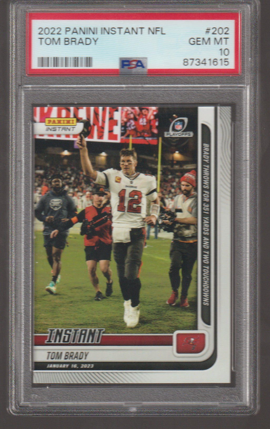 Trading card of Tom Brady in a sports jersey with a PSA grading label on top.