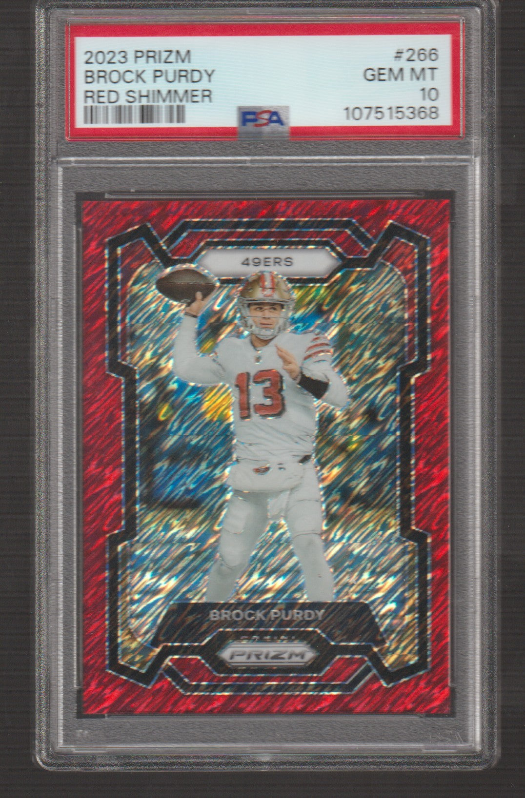 Trading card of Brock Purdy with red shimmer finish, encased in a protective holder.