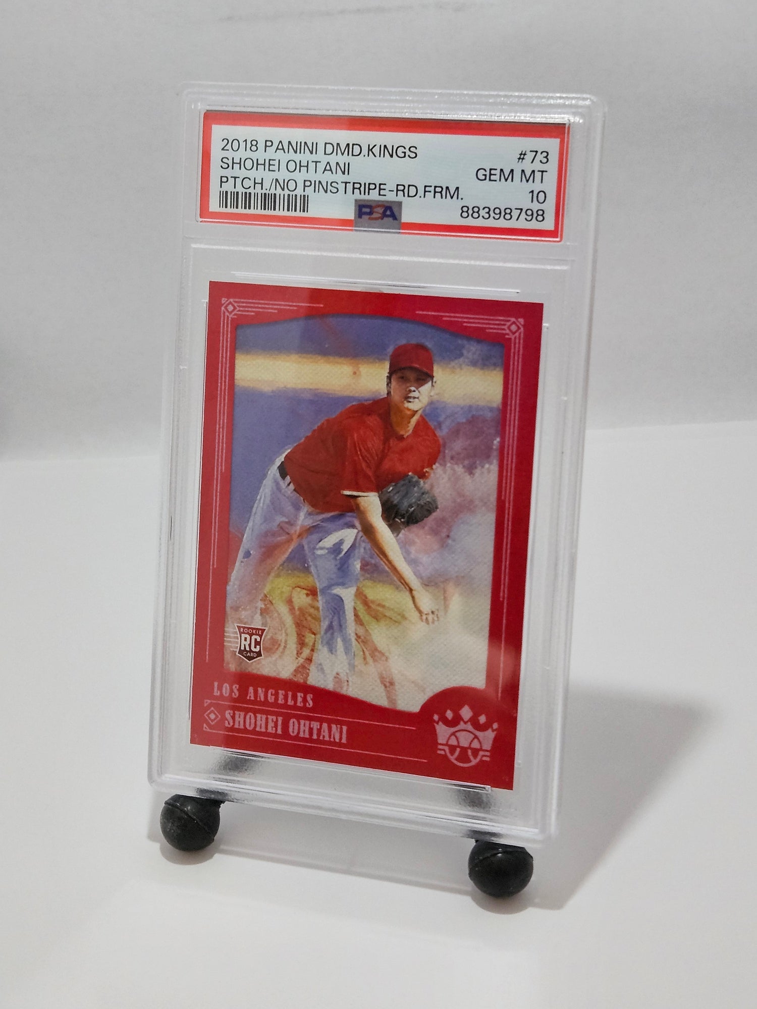 Baseball trading card in a clear holder on a white background