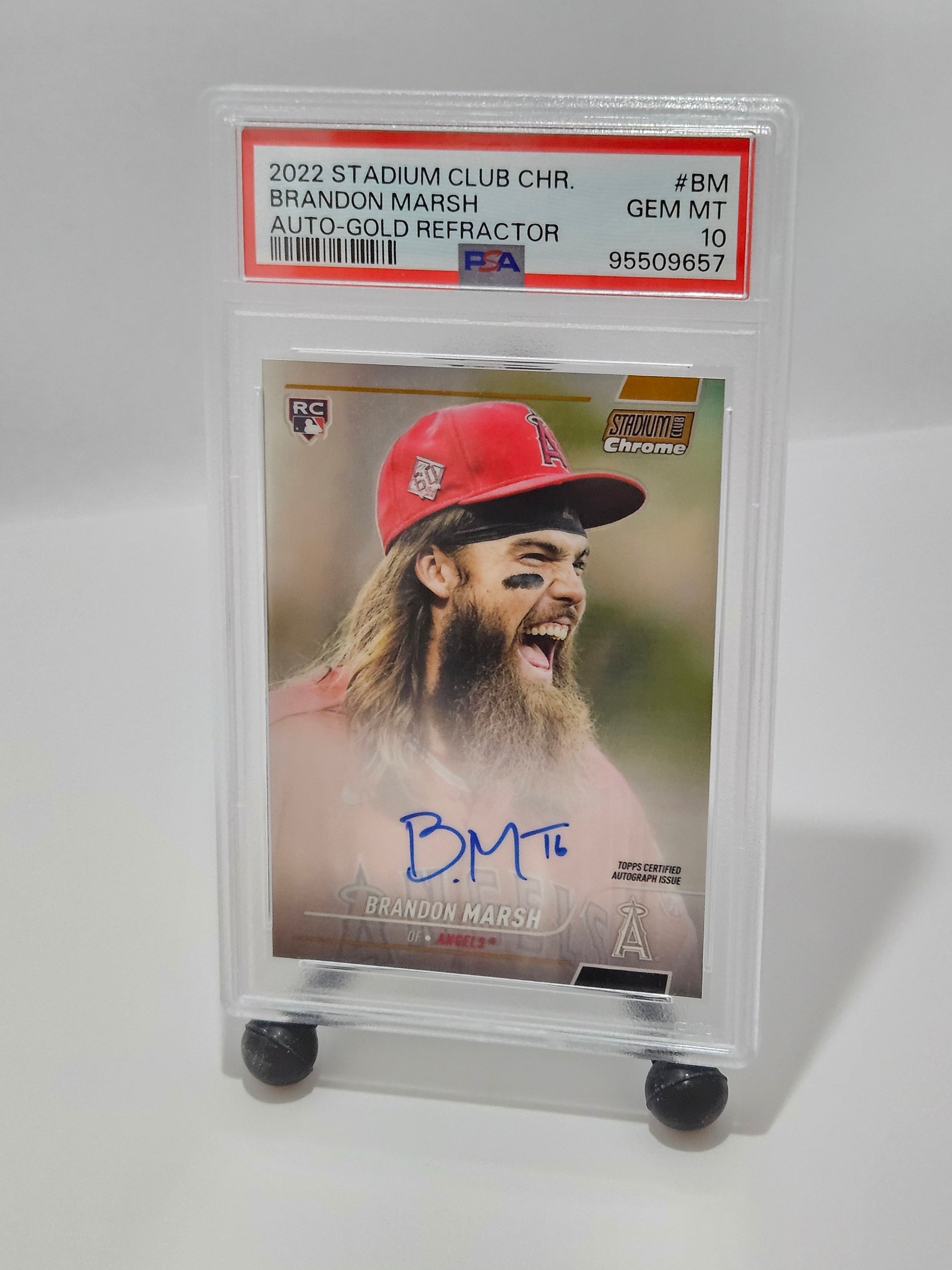 Baseball trading card of a player in a red cap with a white background