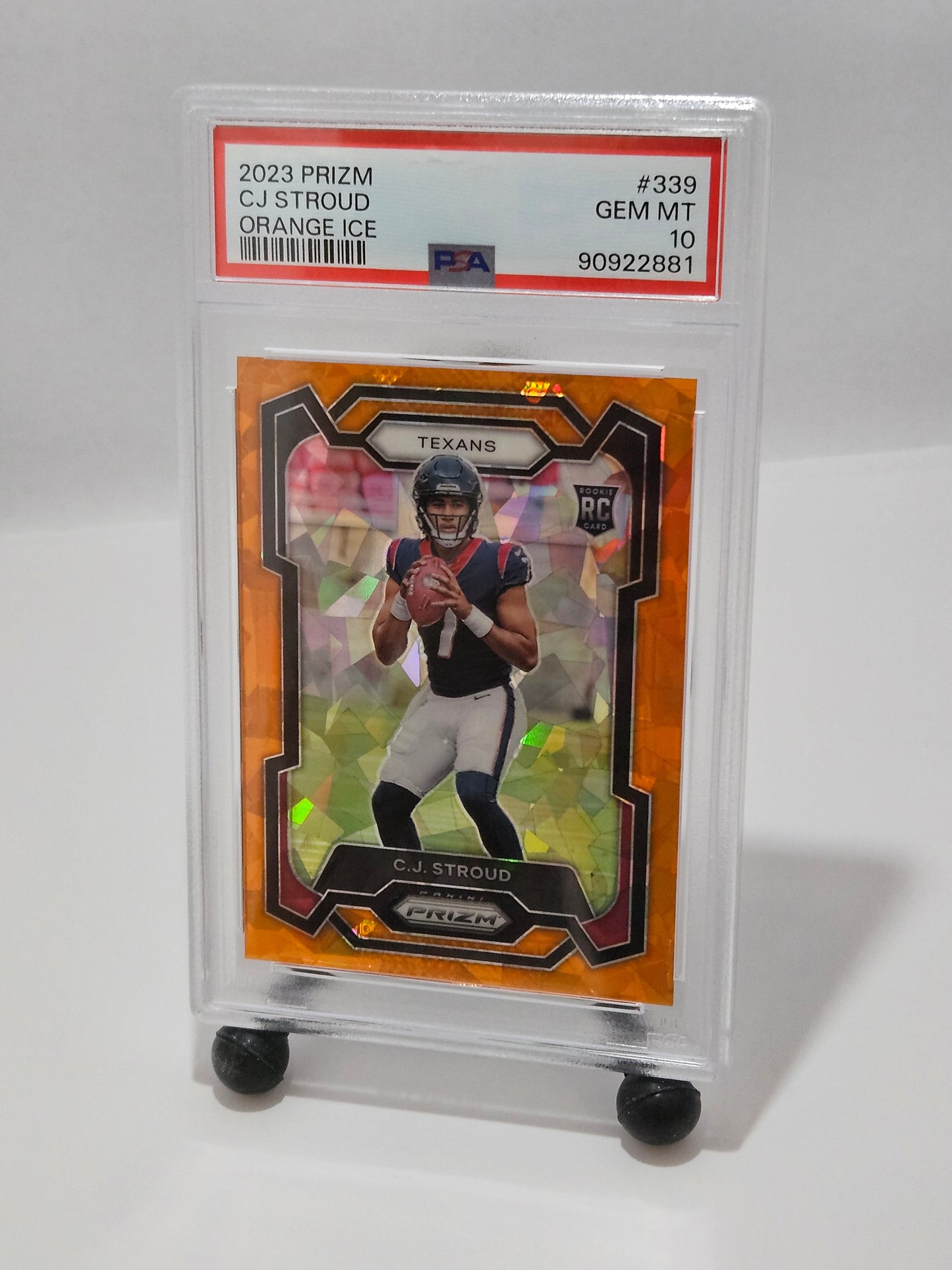 Trading card of a football player in a clear protective case on a white background