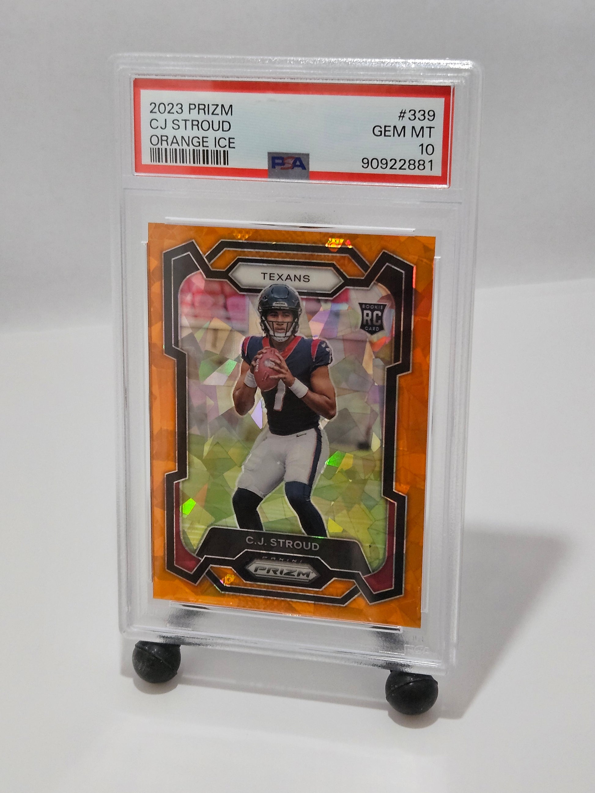 Trading card of a football player in a clear protective case on a white background