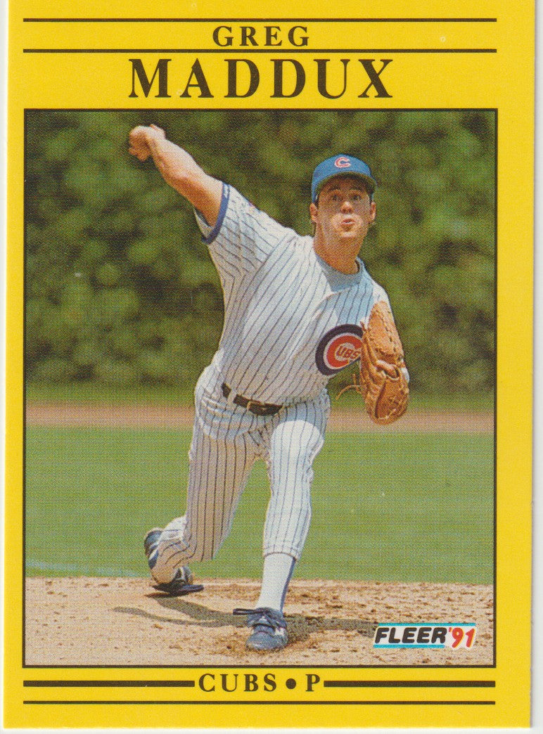 Baseball trading card of Greg Maddux in a Cubs uniform with a yellow border.
