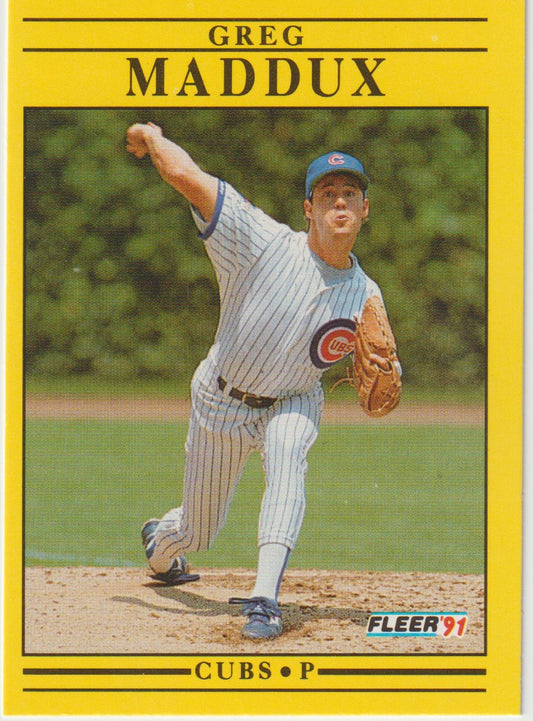 Baseball trading card of Greg Maddux in a Cubs uniform with a yellow border.