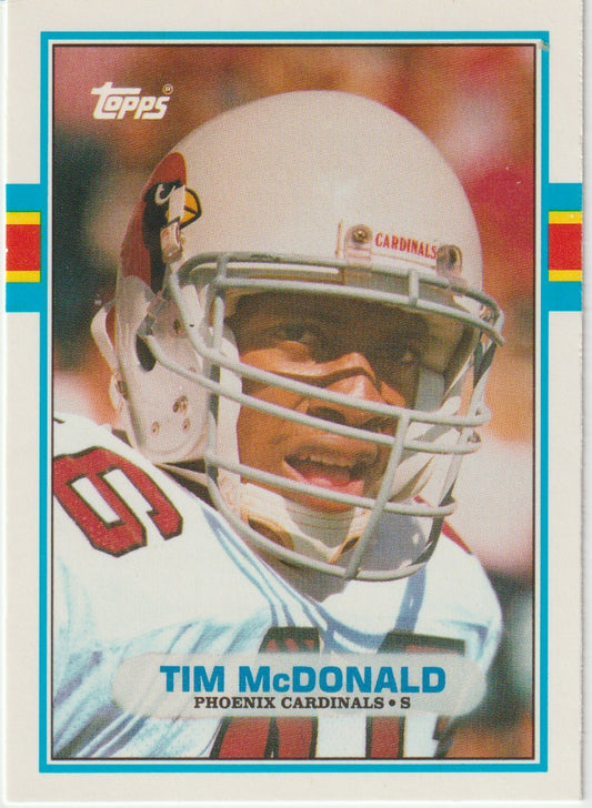 Vintage football trading card of Tim McDonald wearing a helmet with 'Cardinals' logo, featuring Topps branding.